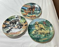 Front view of all three plates showing dog scenes