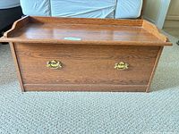 front view of wooden blanket chest showing hardware and finish