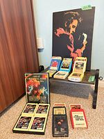 Overall lot view showing tapes, Elvis plaque, small table
