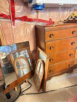dresser with mirrors leaning against it