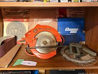 Shelf view with Black & Decker circular saw, staple gun, blades, sanding belt