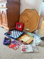 Group shot showing Crokinole board, Po-Ke-No box, cribbage board, checkers board, dominoes, Yahtzee pads