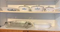 Top shelf CorningWare casseroles showing patterns and lids
