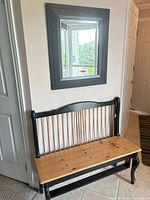 Full view of bench under wall mirror