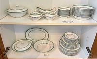 Full contents on cabinet shelves showing all dinnerware pieces