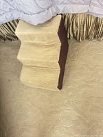 Three-step beige sherpa and brown fabric foam pet stairs beside bed