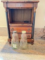 Front view of cabinet showing open shelf and two drawers