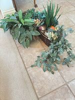 Both plant arrangements on tile floor showing overall size and containers