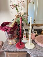 Overview showing glass compote with towels, two wooden towel holders, part of ceramic vase