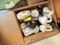 Top view of box showing mixed automotive chemical containers and boxed kit