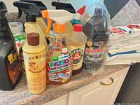Group shot of assorted cleaning supply bottles on countertop