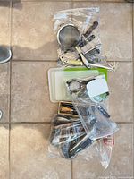Overview of utensils in zip bags on floor