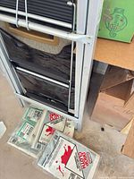 Step stool and packaged drop cloths on floor