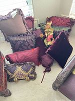 Group shot of assorted pillows and decorative doll on floor