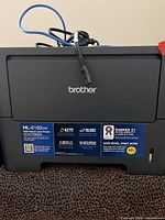Front view of Brother HL-6180DW printer showing model label and general condition