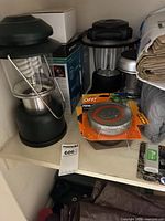 Shelf view showing green lantern, boxed black lantern, OFF! repellent, timer pack