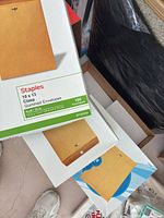 Stack of Staples 10 x 13 clasp gummed envelope boxes