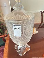 Full view of beverage dispenser with lid and pedestal base