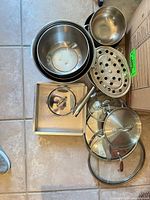 Nested stainless bowls, colander, steamer insert, square pan, assorted lids