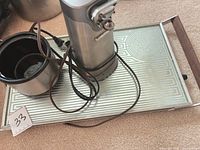 Full view of espresso machine, ceramic cup, power cord on serving tray