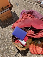 Overall lot showing red tablecloth, placemats, pumpkin sign, binder, in bags