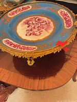 Top view showing blue porcelain bowl, pink cherub reserve and gilt rim