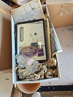 Box containing framed Grapette mirror sign and elephant bottle