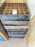 stack of five Grapette wooden crates