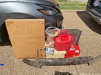 Entire lot showing boxed floor mats, deflector, gas can, bucket with accessories