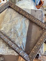 Full view of ornate black and gold wood frame