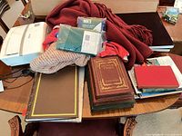 Lot overview showing IDYLIS unit, books, textiles, packaged items on table