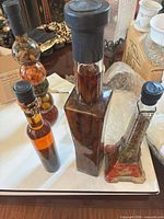 Three decorative glass bottles on tray showing overall lot