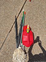 Top view of lot showing mop, umbrellas, poles, and gas can