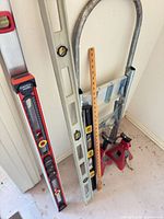 Full group of levels, yardstick, hand truck frame, jack stands
