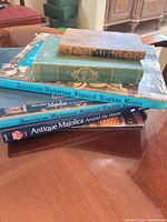 Stack of all five books showing spines and varied sizes