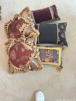 Five decorative pillows arranged on carpet