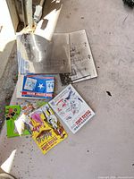 All items laid out showing two large oil field prints and five books/booklets