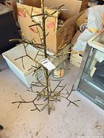 Full view of metal branch tree standing on floor