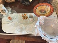 overview of all glass, ceramic and brass items on table