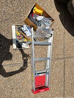 Ladder with two boxes of mixed tools and hardware
