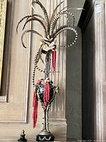 Full view of urn with feather arrangement showing scale and design