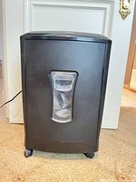 Front view showing waste bin window and casters