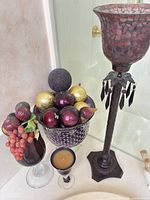 Overview of compote with decorative balls, mosaic candle holder, goblets and candle