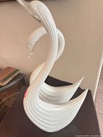 Side view of both ribbed glass swans showing size and form