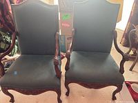 Front view of both carved wood armchairs