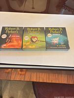 All three sealed audiobook CD sets laid out side by side