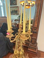 Full view of gilt Rococo five-arm candelabra with candles