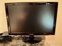 Front view of Samsung HDTV monitor powered on stand