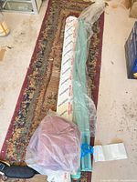 Overall view of Sanderson roll, teal roll and mauve towels on floor