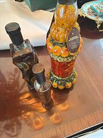 Three decorative glass bottles on table